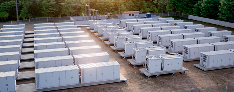 Vista aérea de um pátio com várias unidades modulares/containerizadas alinhadas, associadas a infraestrutura energética e armazenamento.